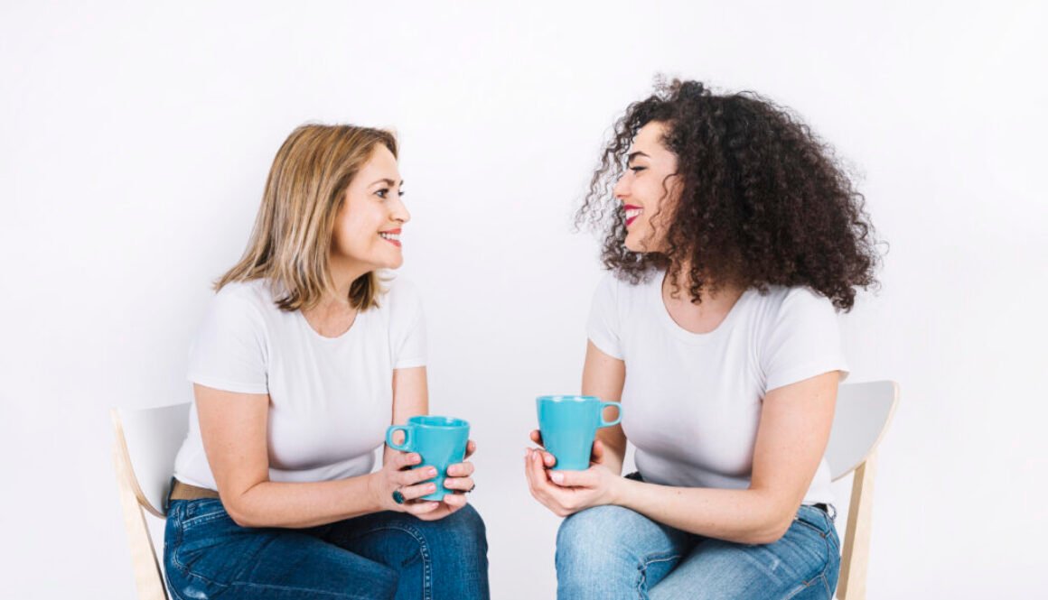 women-with-mugs-smiling-talking
